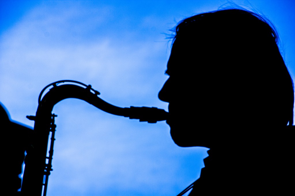 A silhouetted sax man wails on his horn at the first Brews & Blues Bash on N. Front Street.  