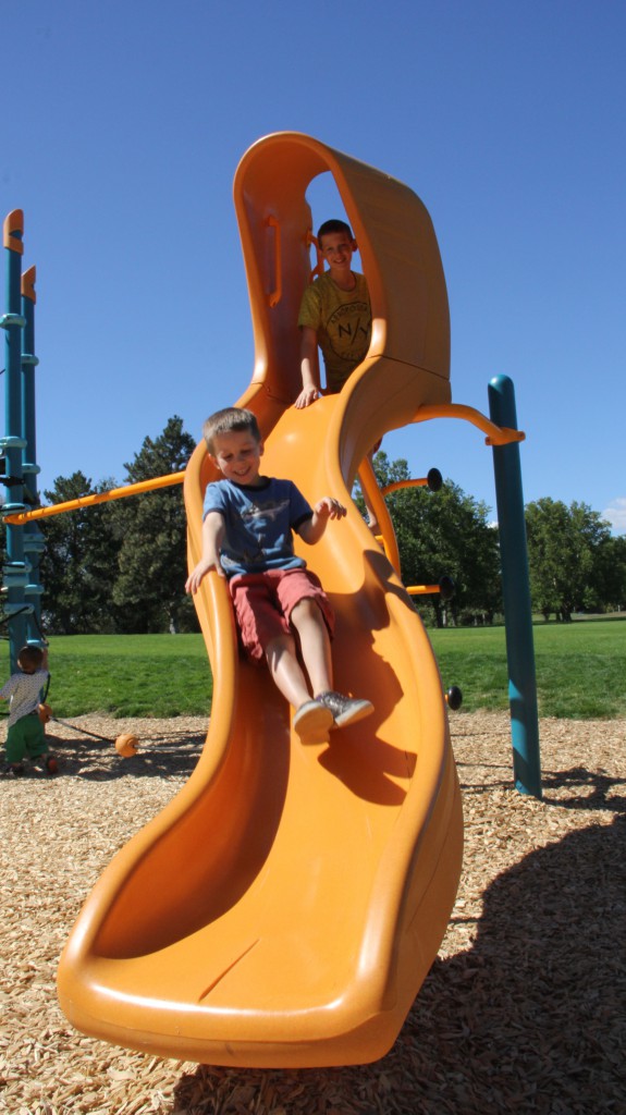 Brothers Kyle and Kasey Weishaar enjoy a ride one of the new slides put in recently at Yakima’s Randall Park by the Downtown Yakima Rotary Club. 