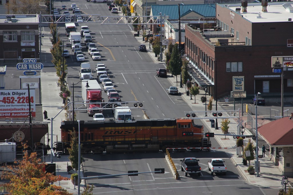 Cars wait at the cross arms on Yakima Avenue as a Burlington Northern rolls by.