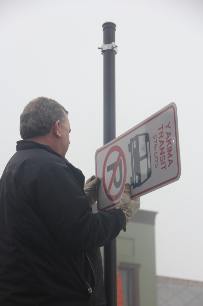 Transit Driver Dave Edwards removes Yakima Transit Route signs along Yakima Avenue which was part of the recently eliminated Yakima Transit Route 8. 