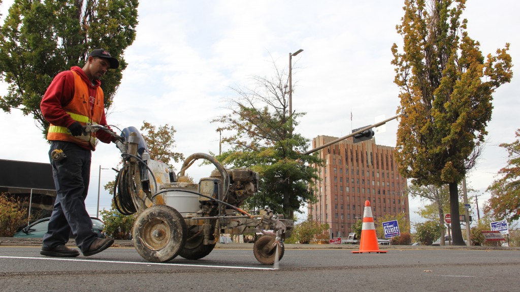 Gabriel Chavez of Stripe Rite Inc. lays down a new line as parking changes come to Downtown Yakima.