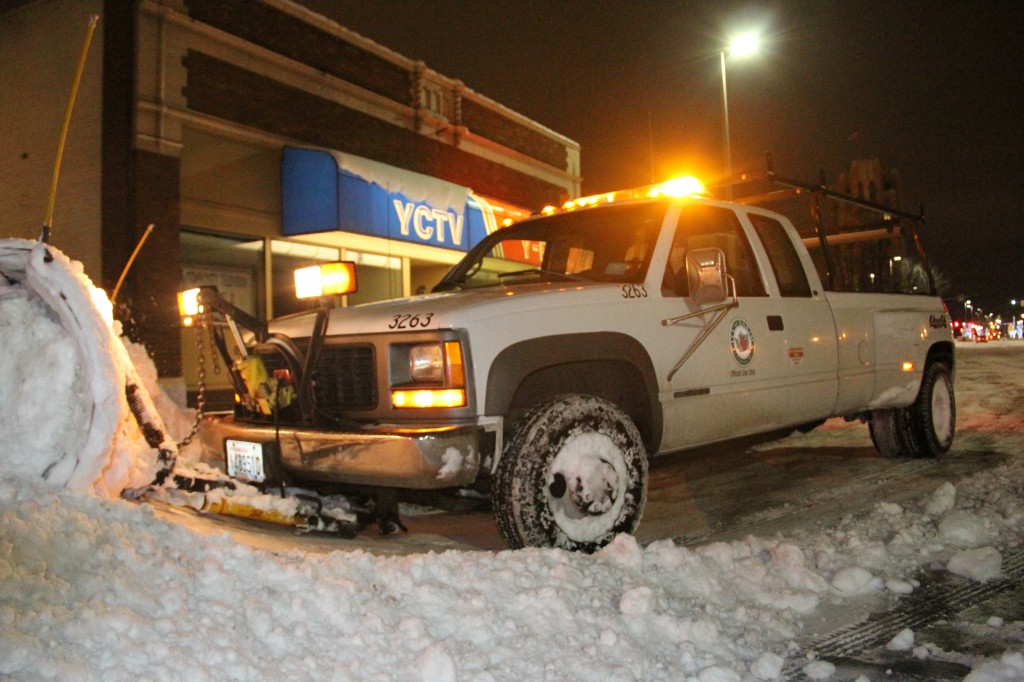 City of Yakima Building Superintendent Randy Pitney helps clear parking spaces near Yakima Community Television following several inches of snowfall over the weekend.