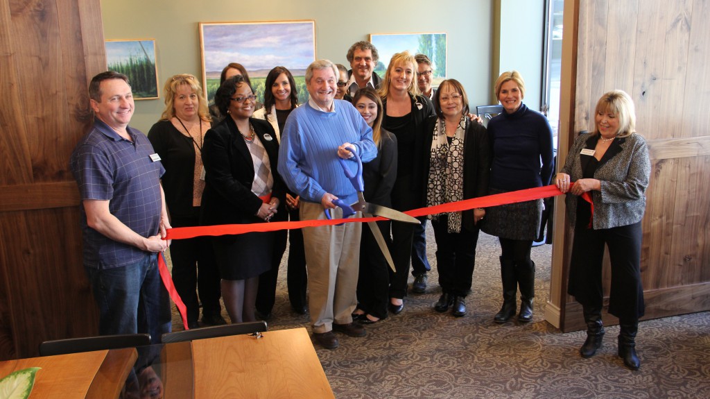 Representatives from JEM Development and the Yakima Chamber of Commerce are on hand to cut the ribbon marking the official opening of the new boutique Hotel Maison in Downtown Yakima.