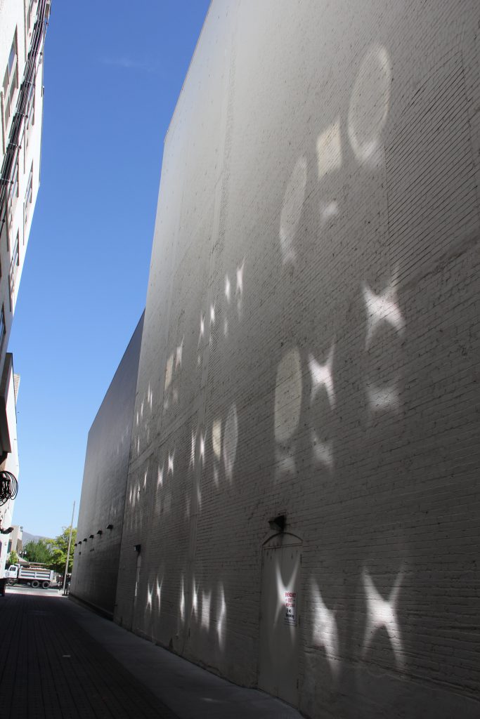 Reflections from the  windows across the alley from the Capitol Theatre create a stunning kaleidoscope like effect on the buildings north wall creating Yakima's own naturally occurring light art. 