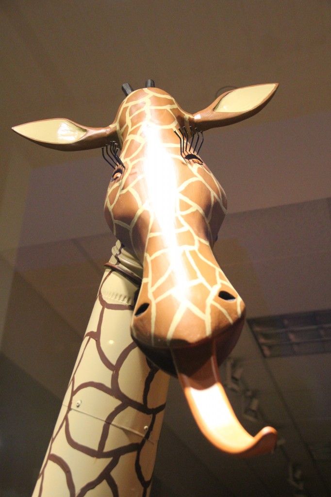A wooden giraffe seems to have a taste for art as part of the Windows Alive! displays on Yakima Avenue.  