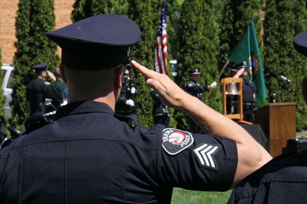 A Yakima Police sergeant salutes during the  presentation of colors at a memorial honoring the 124 Peace Officers killed in the line of duty over the last year.