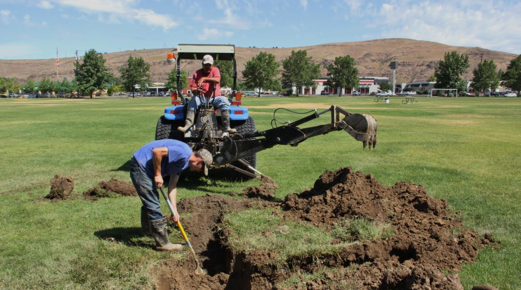 Parks and Recreation employees Juan Ramos and Brandon Smith hit the layer of volcanic ash now buried about 2 and ½ feet under the surface while repairing an irrigation line. 36 years ago tons upon tons of Mt St Helens ash were dumped at the area now known as Chesterly Park following the 1980 eruption.