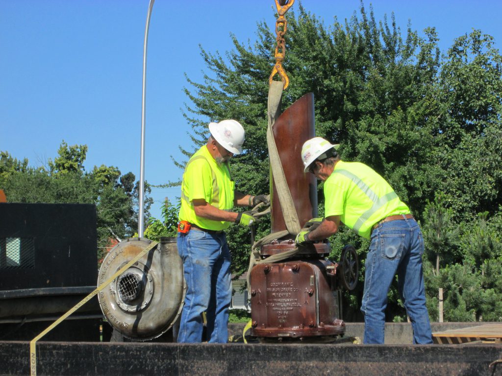 Crews install art work at the Fair Avenue roundabout.