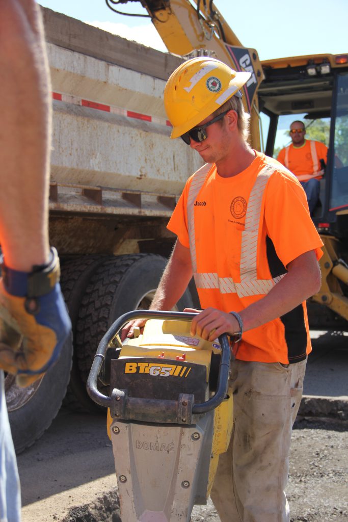 Waterworks Specialist Jacob Gray packs down gravel after the City of Yakima Water & Irrigation division found and fixed a leaking water pipe on South 3rd Street. 