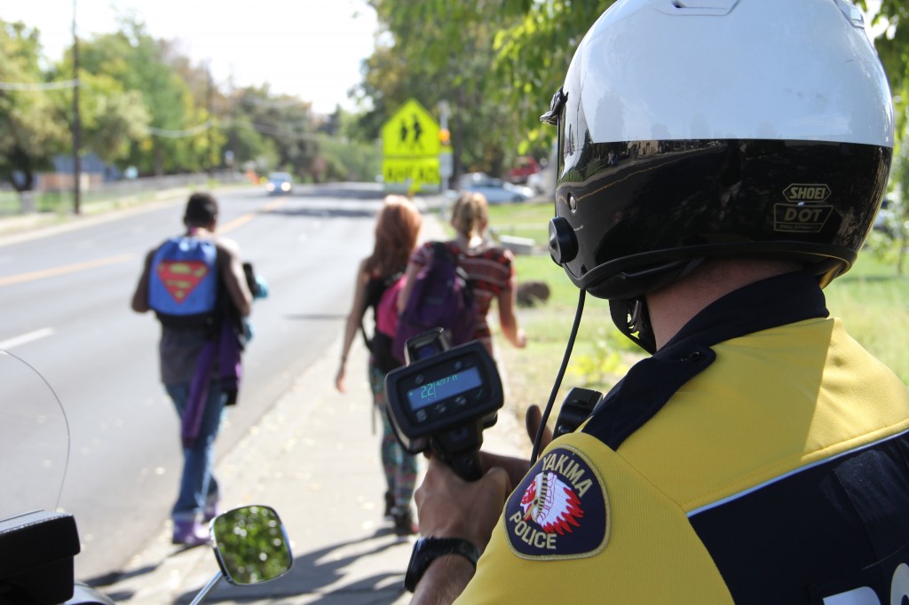 A YPD motorcycle patrol officer checks for speeding cars in a school zone near McClure elementary on 24th Avenue.