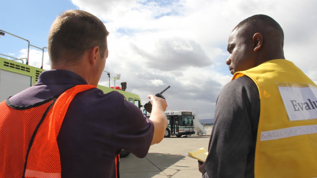 Airport Manager Rob Peterson describes the scene to an evaluator during a full scale live emergency exercise at the Yakima Airport.  