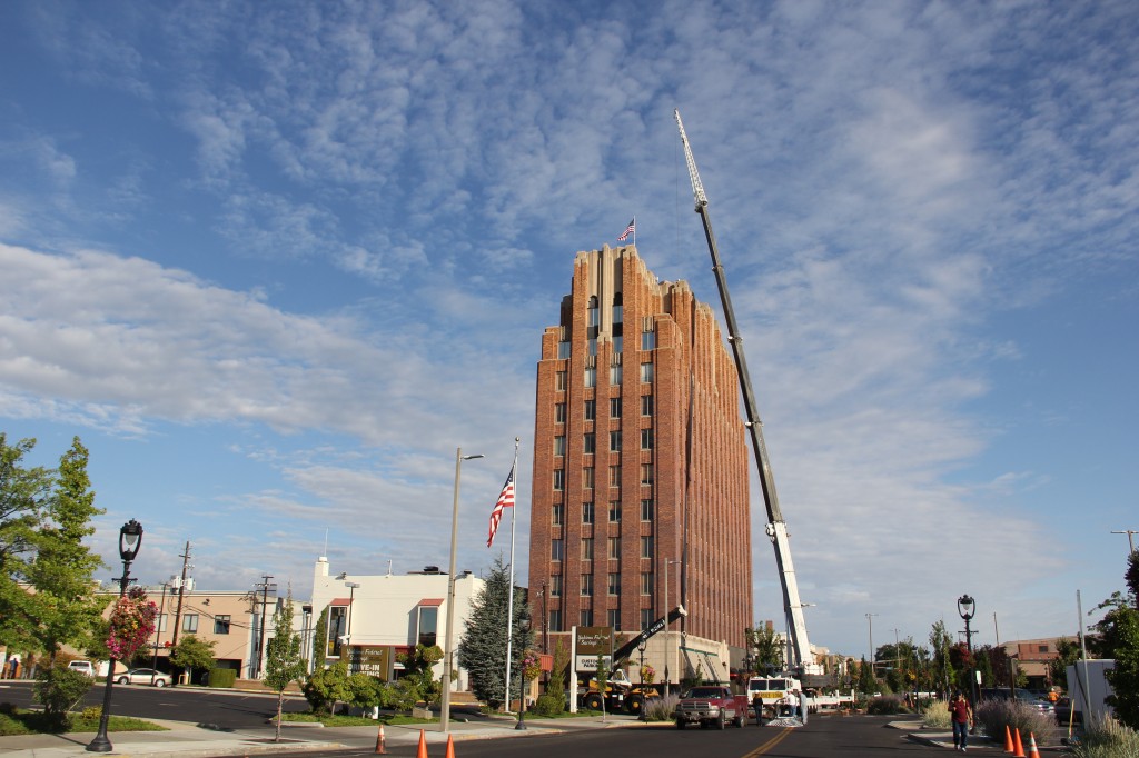 A crane stretches above the Larson Building lifting communications equipment for Radio Yakima's downtown relocation. 