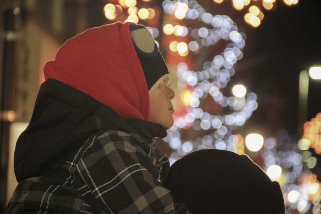 Jackson Brannum contently watches the 14th Annual Holiday Light Parade in Downtown Yakima from atop his dad Brian’s Shoulders. 