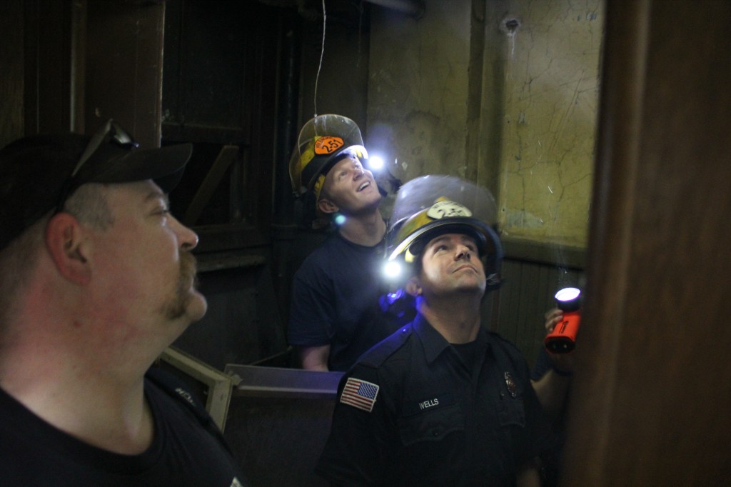 West Valley Fire Fighters look into a ceiling panel following a joint training session with the Yakima Fire Department at Yakima’s Wilson Building. 